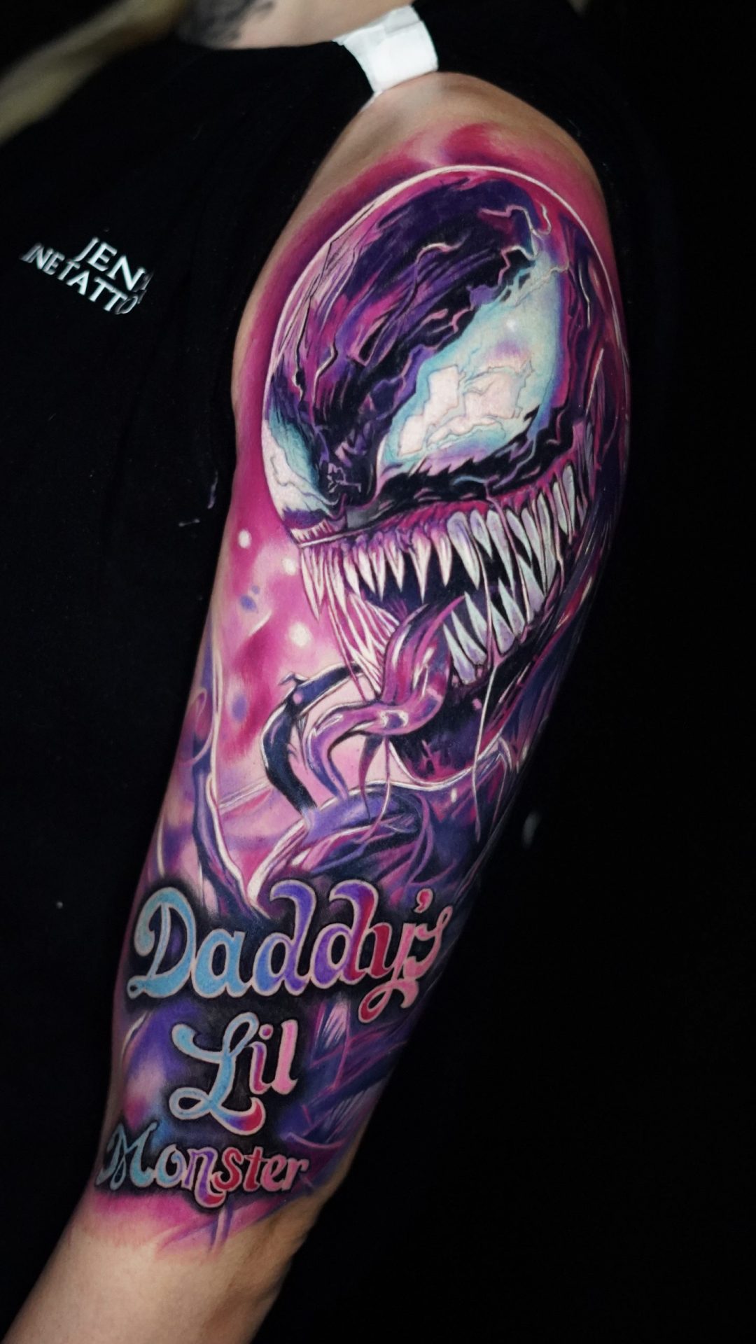 Rosa Tattoo, das ein Monster mit scharfen Zähnen darstellt.